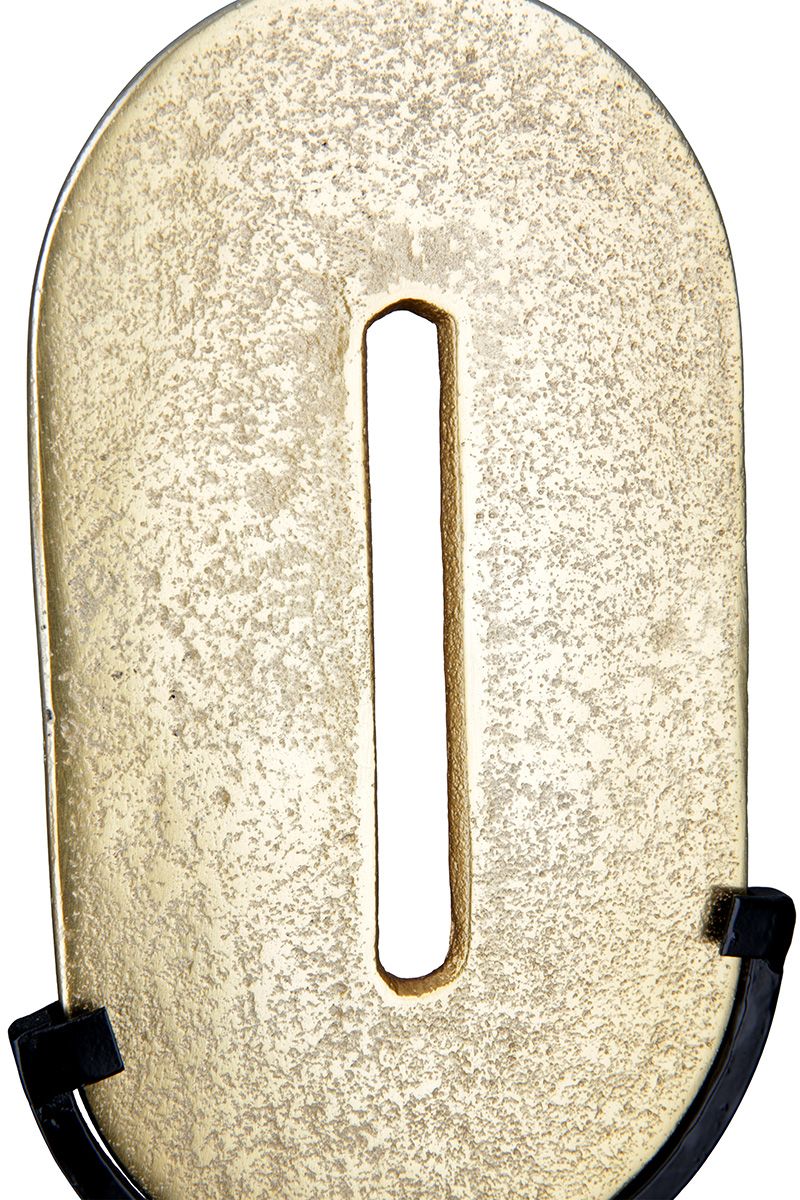 Zero Gold-colored, round object on a black metal stand