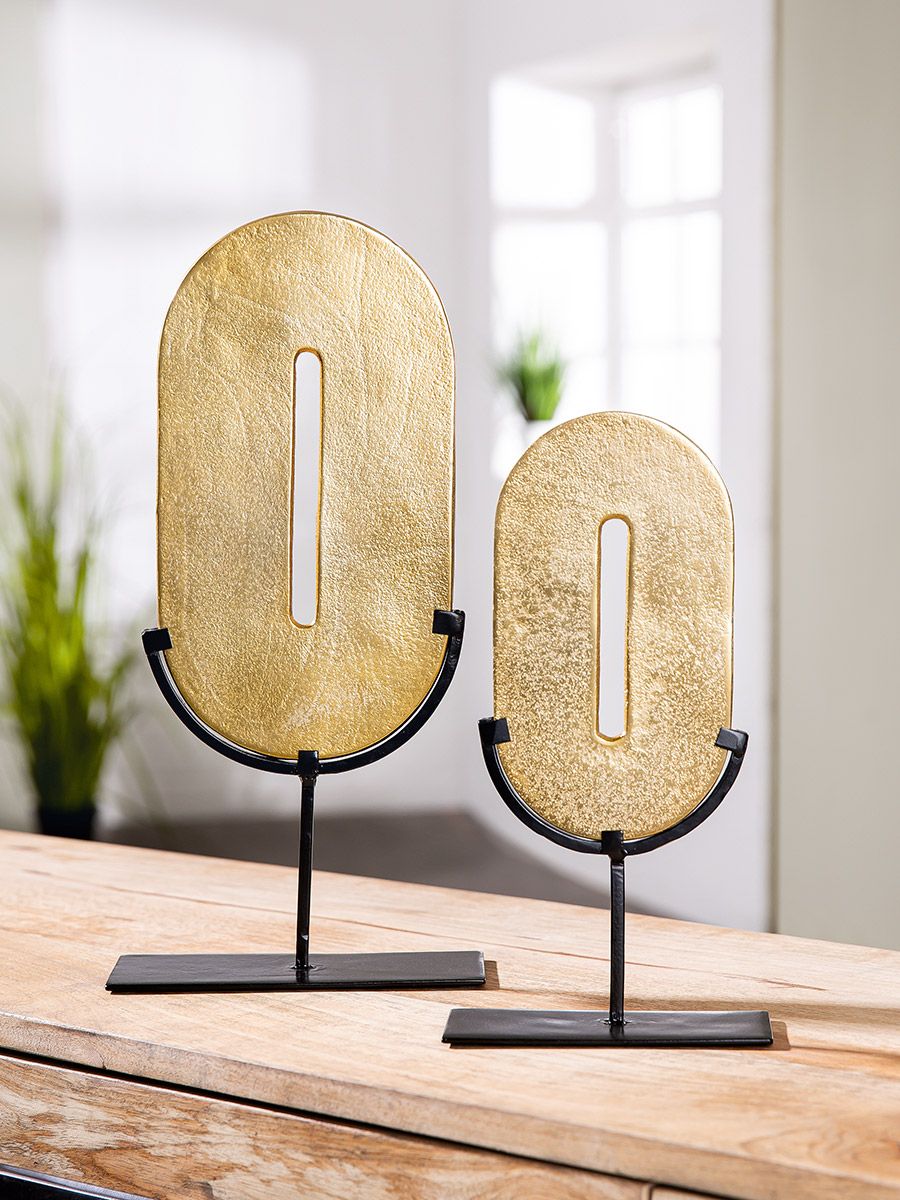 Zero Gold-colored, round object on a black metal stand