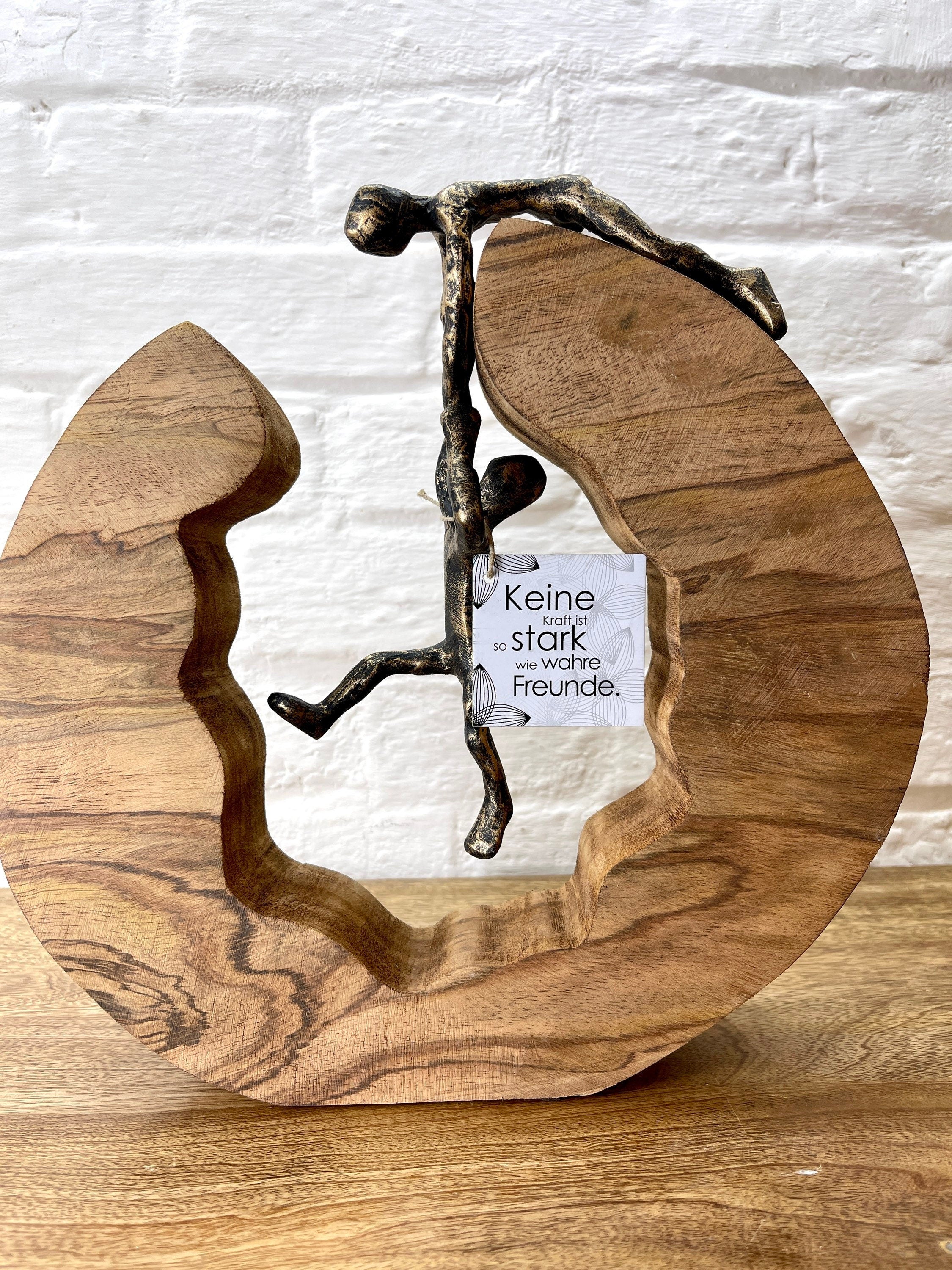 Bronzefarbene Skulptur Teamwork Symbol für Zusammenarbeit und Freundschaft