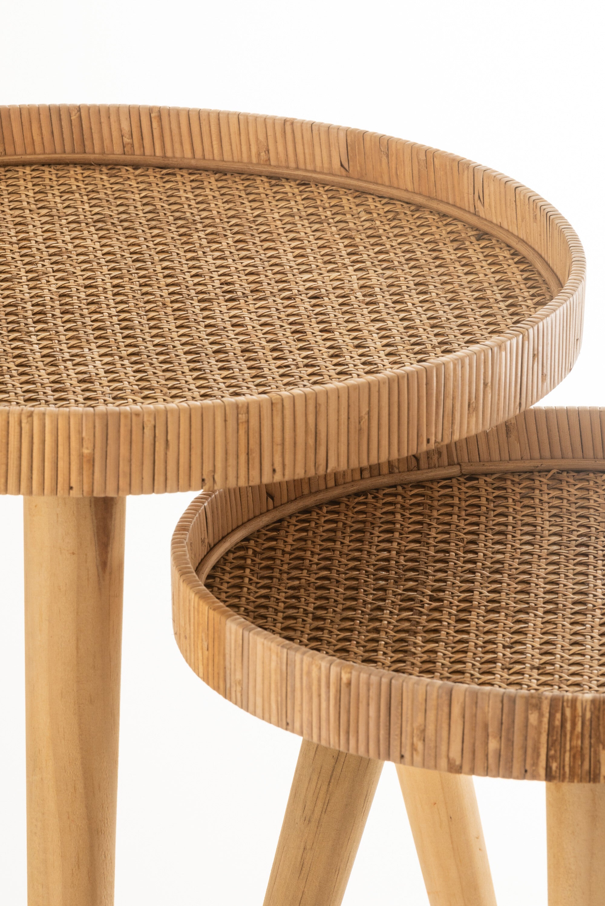 Set of two round, three-legged rattan side tables