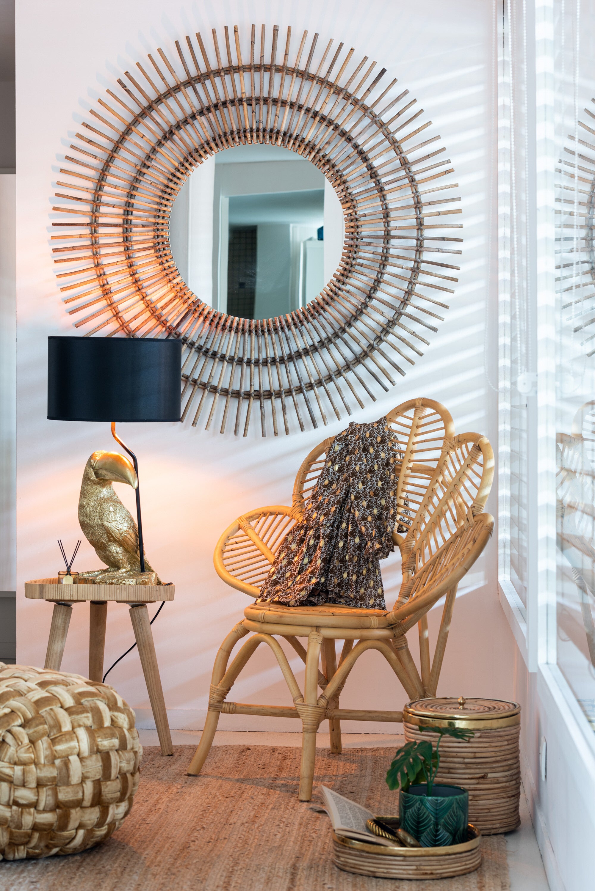 Set of two round, three-legged rattan side tables