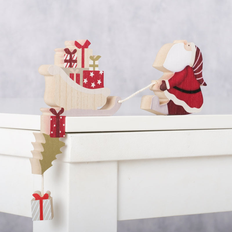 Weihnachtsdeko Kantenhocker Hauke - Holz Weihnachtsmann mit Schlitten 27cm
