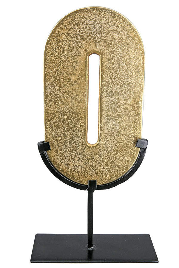 Zero Gold-colored, round object on a black metal stand
